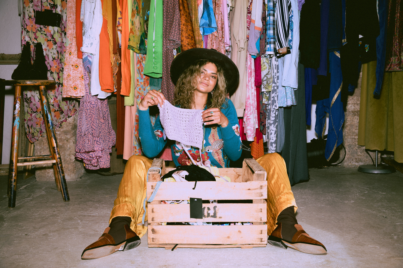 Stylish Woman Thrifting Clothes in a Vintage Shop